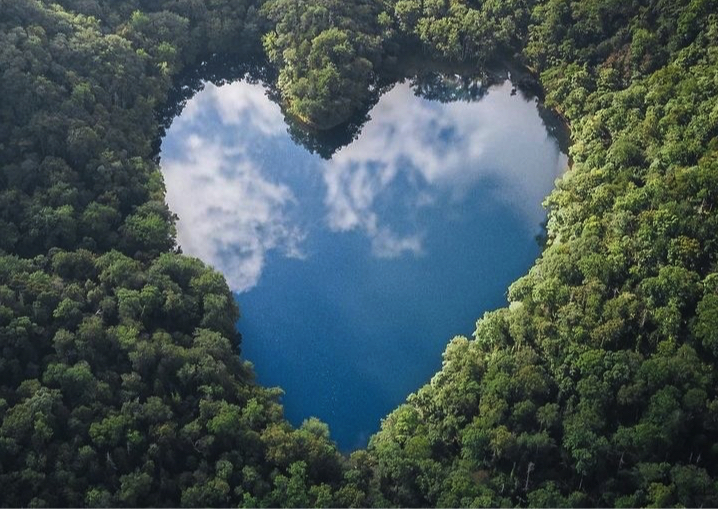 Heart-shaped lake surrounded by trees in a forest-scene from Hokkaido, the northernmost island of Japan.